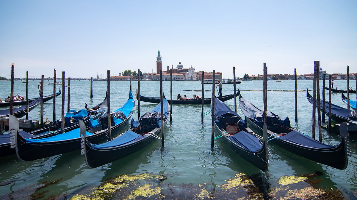 Tourists enjoy a gondola ride in front of St. Mark square during the Italian Republic Day on June 2 in Venice, Italy.