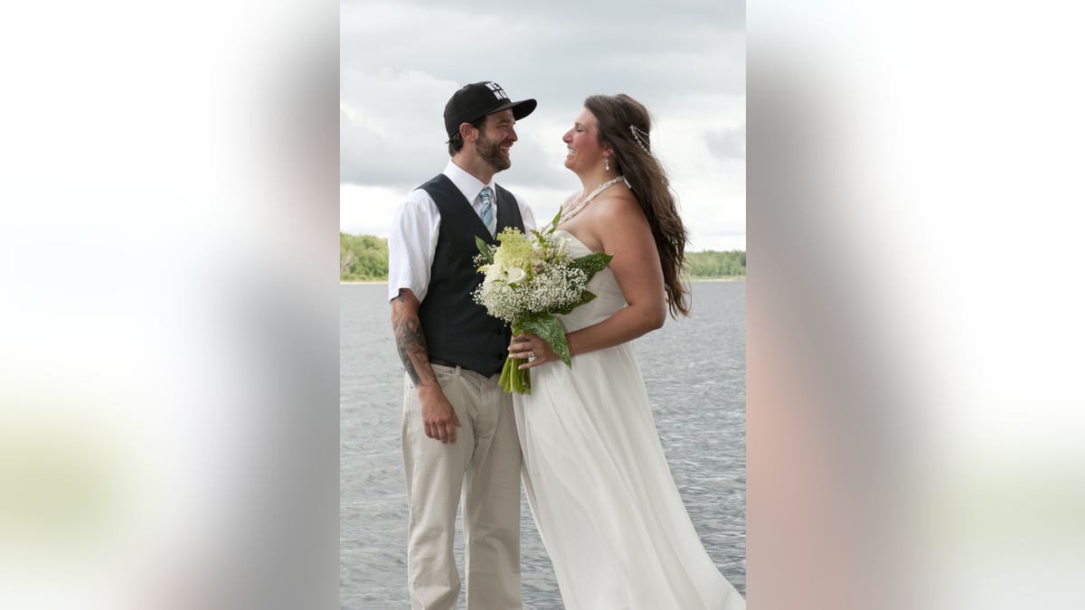 Canadian couple Lora Wendorf and Jordan Devries were posing for photos on a riverside dock on the big day when they broke out a bold dance move for a dramatic picture.