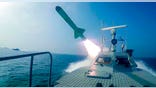 In this photo released Tuesday, July 28, 2020, by Sepahnews, a Revolutionary Guard's speed boat fires a missile during a military exercise. Iranian commandos also fast-roped down from a helicopter onto a replica of an aircraft carrier in the exercise called "Great Prophet 14." The drill appears aimed at threatening the U.S. amid tensions between Tehran and Washington. (Sepahnews via AP)