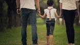Daughters, parents were holding hands in the park