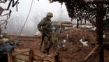 FILE - In this file photo dated Monday, Dec. 9 2019, a Ukrainian soldier takes position on the front line at the town of Novoluhanske in the Donetsk region, Ukraine.   Ukrainian and rebel forces in war-torn eastern Ukraine have started preparing for a “full and comprehensive” ceasefire scheduled to begin at midnight on Monday July 27, 2020. Rebel officials said Sunday they have instructed their troops about the ceasefire and issued a decree banning weapon use, while Ukraine's president said that if upheld, it would “pave the way for implementing other clauses” of the Minsk peace deal.