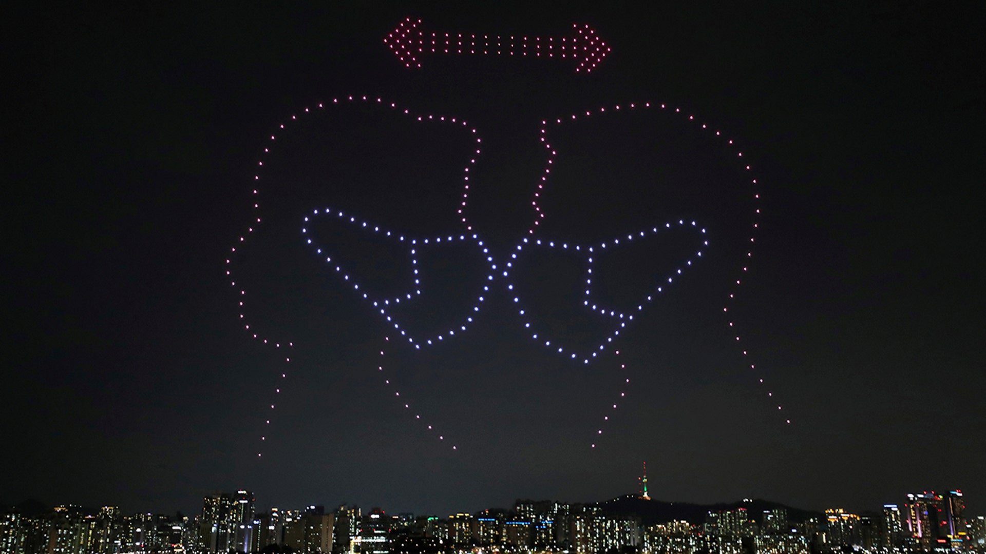 Drones fly over the Han river showing messages to help avoid the spread of the coronavirus in Seoul, South Korea, July 4, 2020.