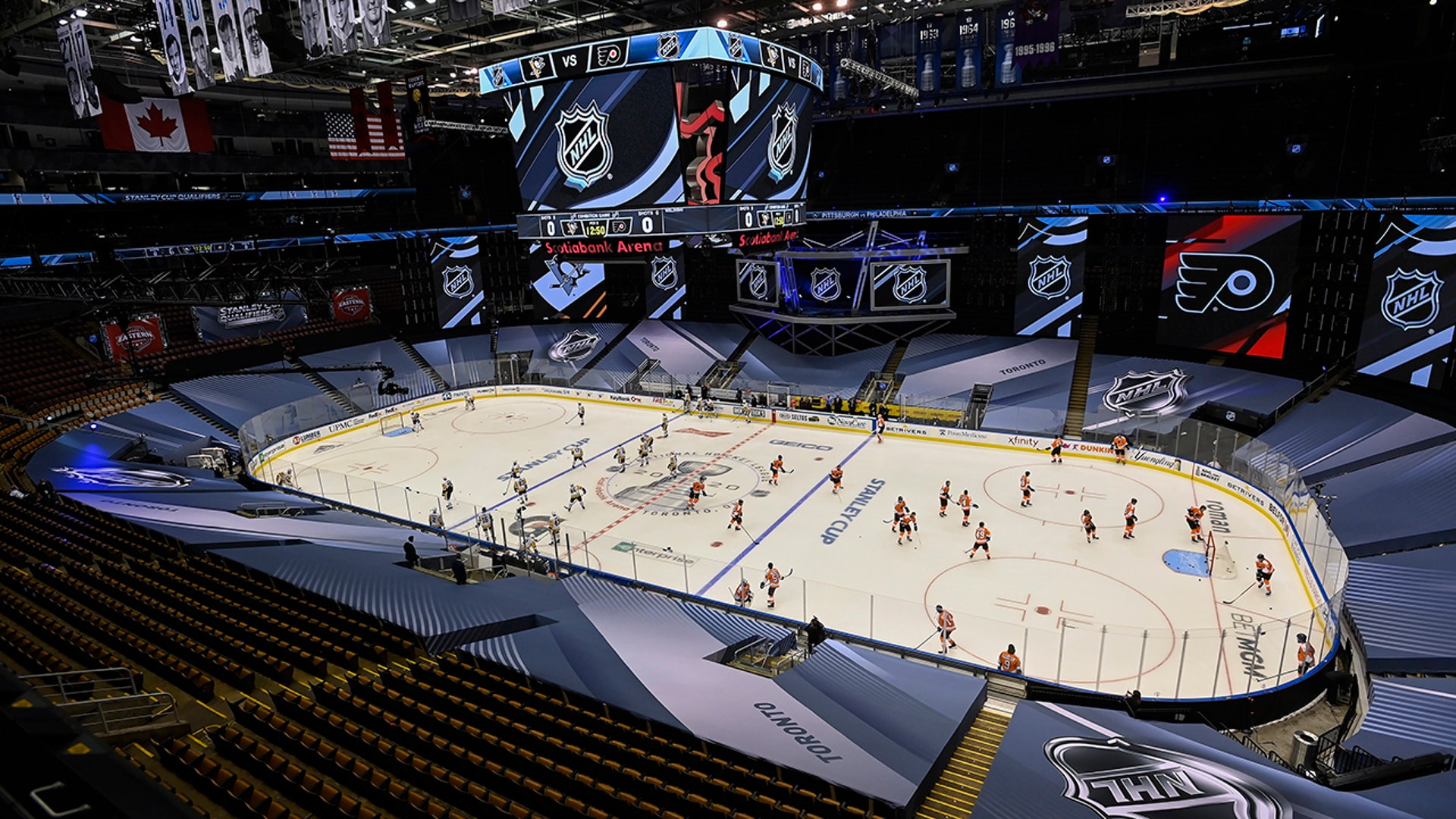 The Pittsburgh Penguins and Philadelphia Flyers warm-up before an exhibition NHL hockey game in Toronto, July 28, 2020.