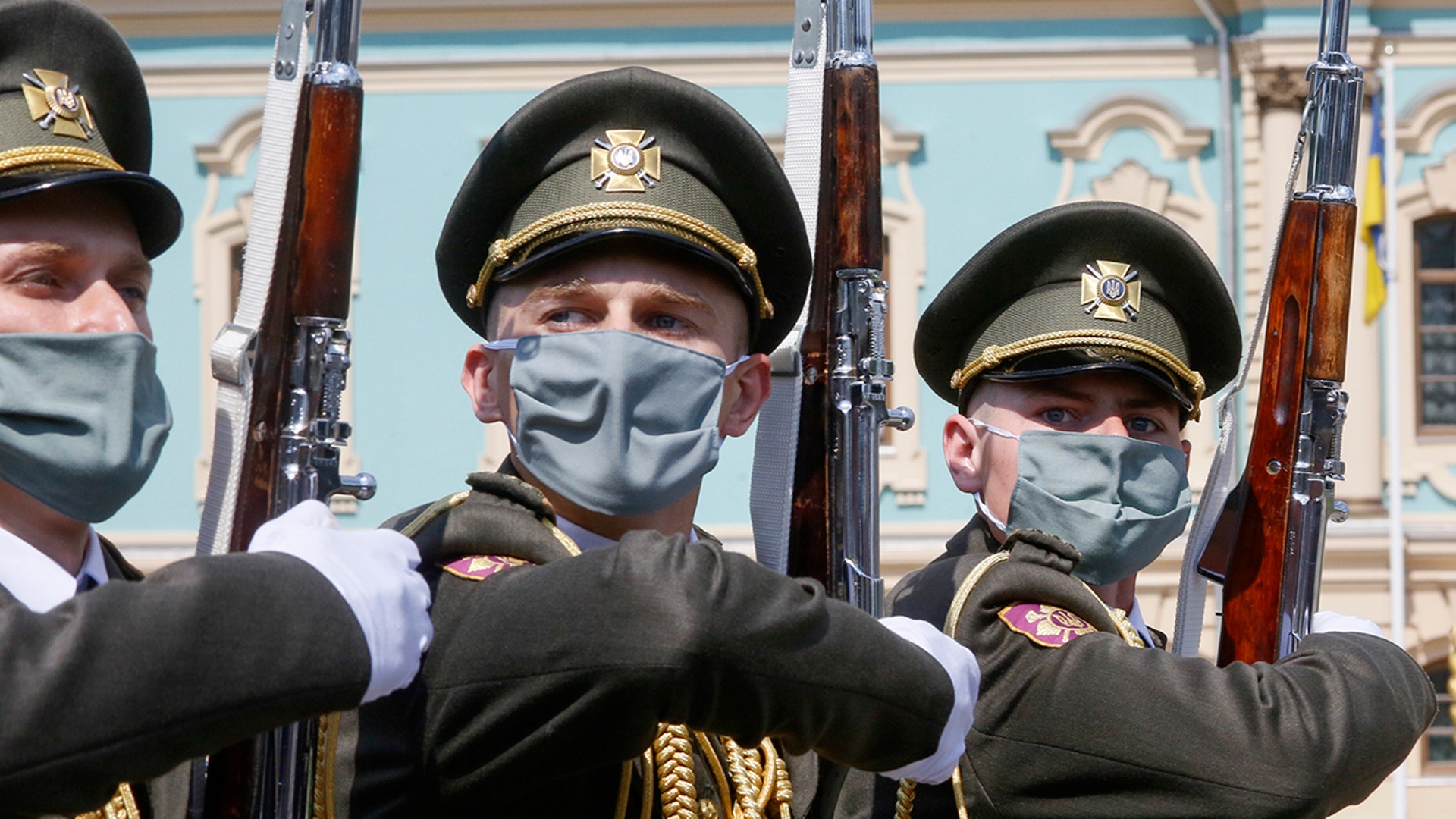 Honor guard soldiers wearing face masks march during a welcome ceremony for Swiss Federal president Simonetta Sommaruga in Kyiv, Ukraine, July 21, 2020. 