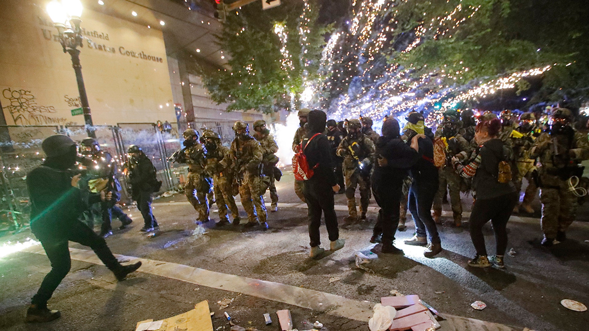 Federal officers advance on demonstrators during a Black Lives Matter protest at the Mark O. Hatfield United States Courthouse in Portland, July 25, 2020.
