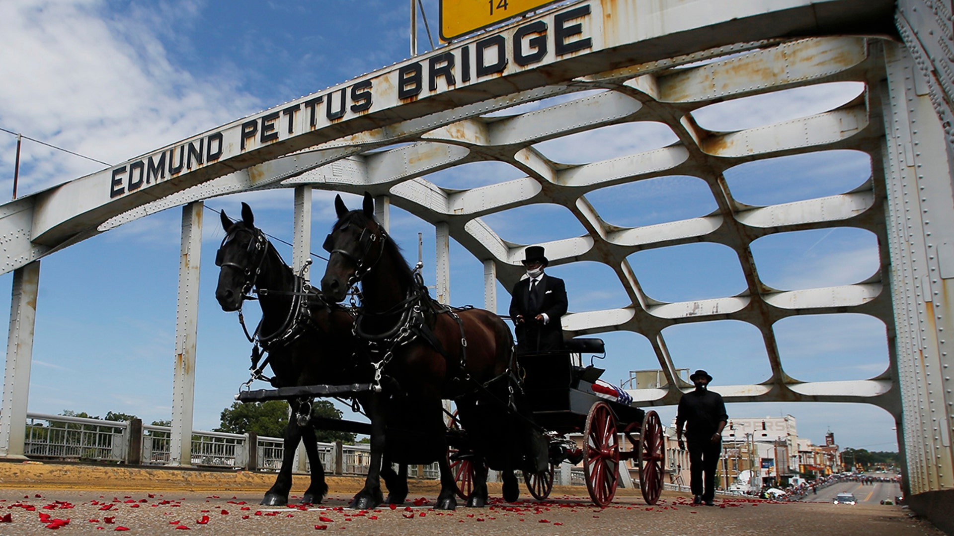 The casket of Rep. John Lewis moves over the Edmund Pettus Bridge by horse-drawn carriage during a memorial service for Lewis in Selma, Ala., July 26, 2020.