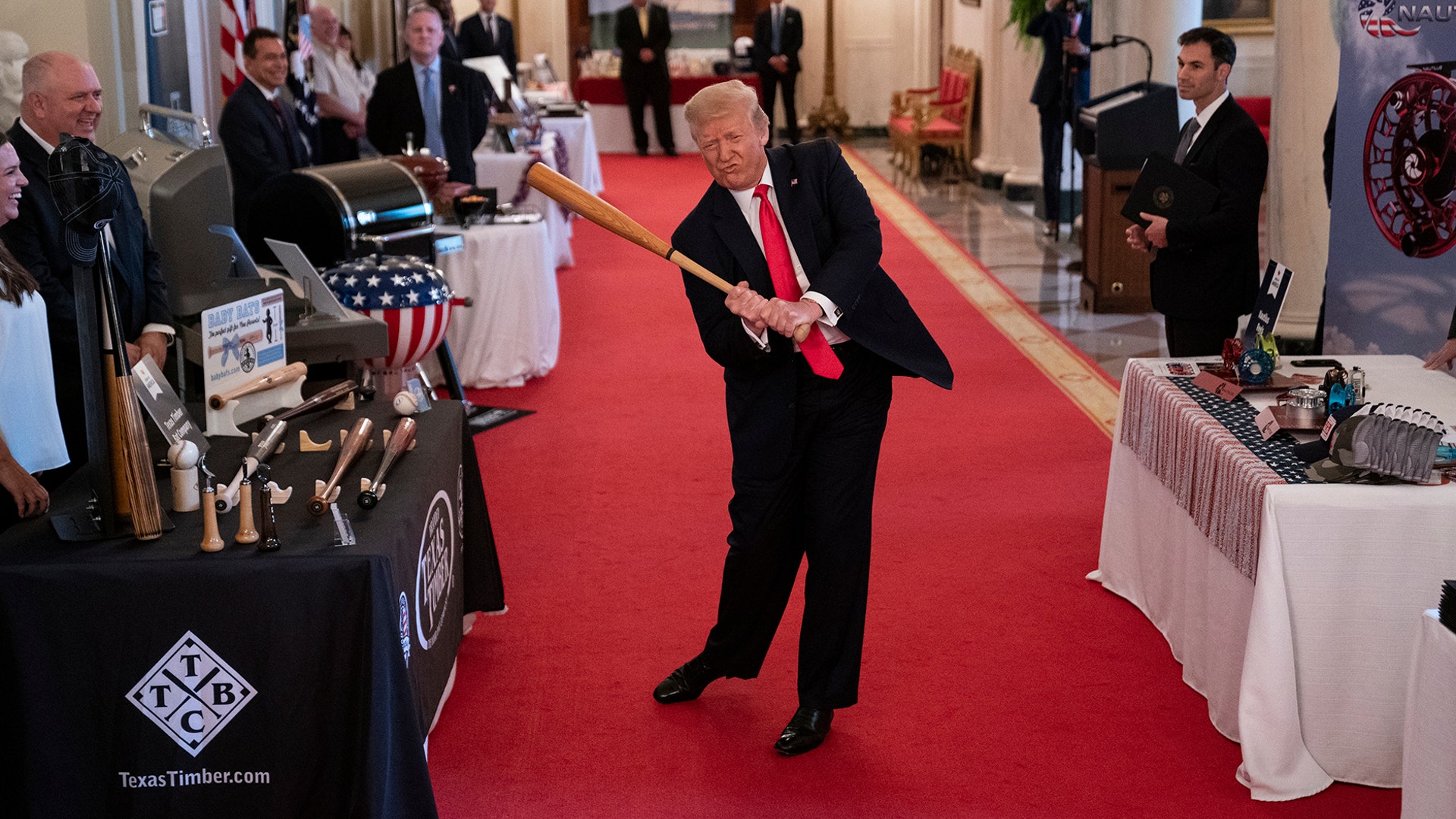 President Donald Trump swings a baseball bat during the Spirit of America Showcase at the White House in Washington, July 2, 2020