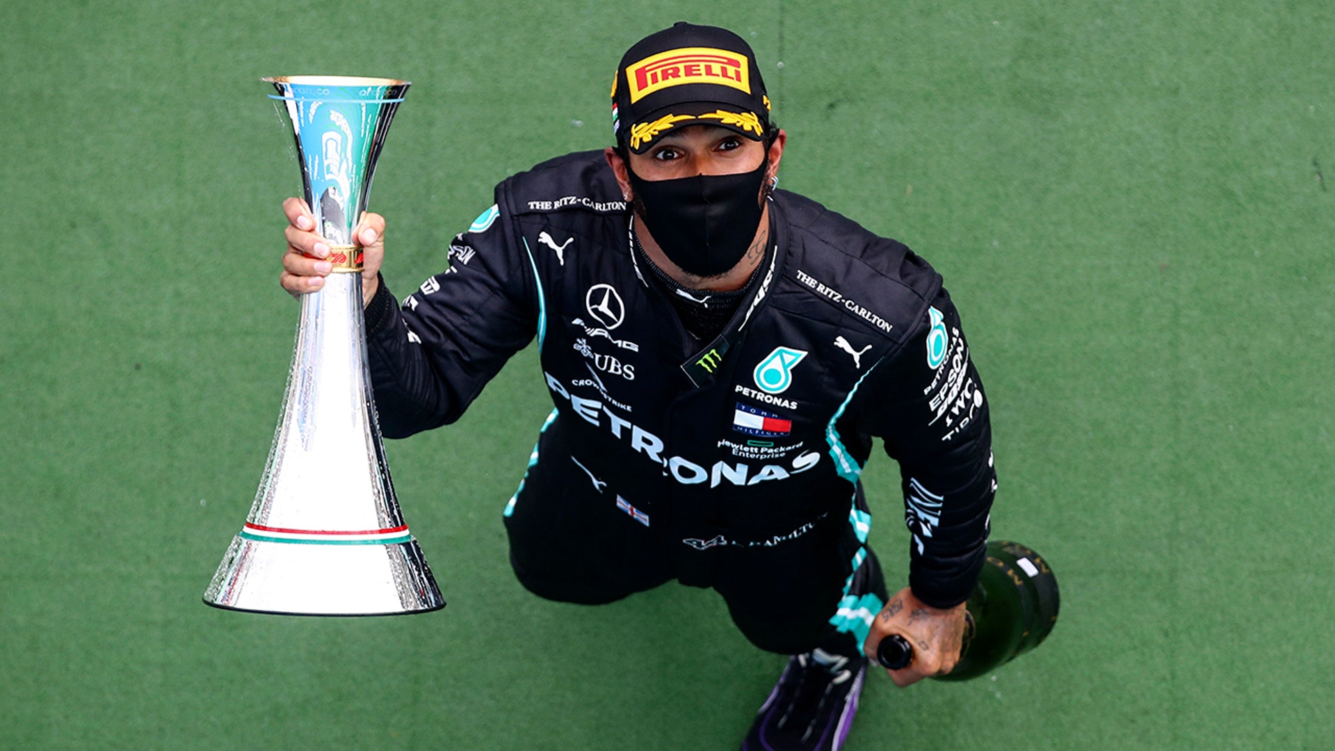 Mercedes driver Lewis Hamilton of Britain holds the trophy after winning the Hungarian Formula One Grand Prix race in Mogyorod, Hungary, July 19, 2020. 