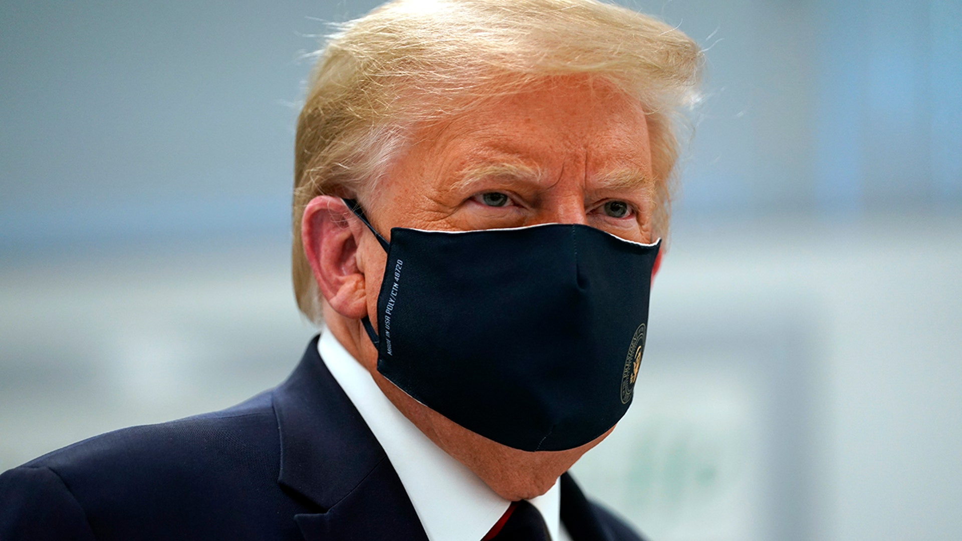 President Donald Trump wears a face mask as he participates in a tour of the Bioprocess Innovation Center at Fujifilm Diosynth Biotechnologies in Morrisville, N.C., July 27, 2020.