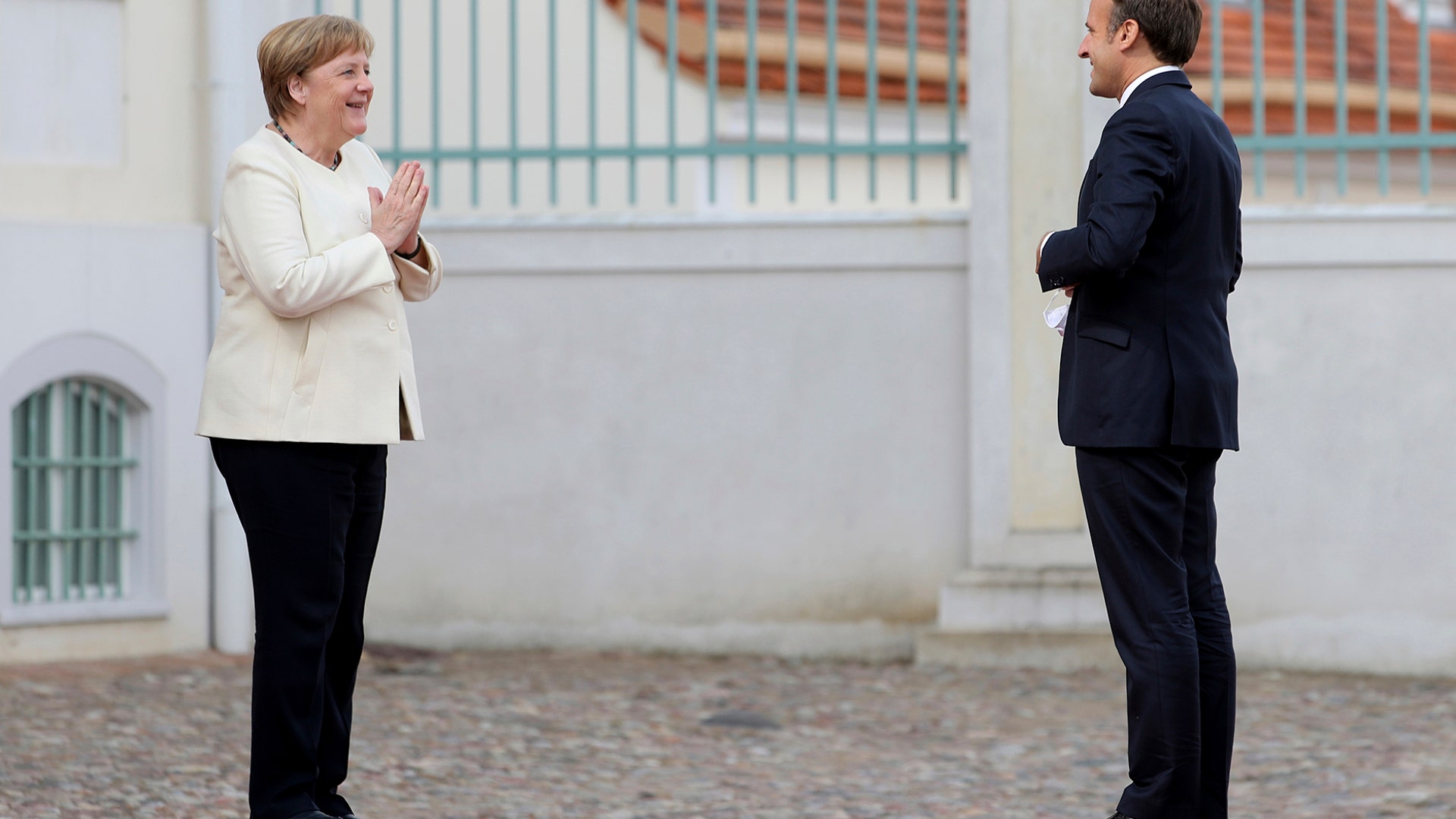 German Chancellor Angela Merkel welcomes French President Emmanuel Macron at the German government's guest house Meseberg Castle in Gransee Germany, June 29, 2020. 