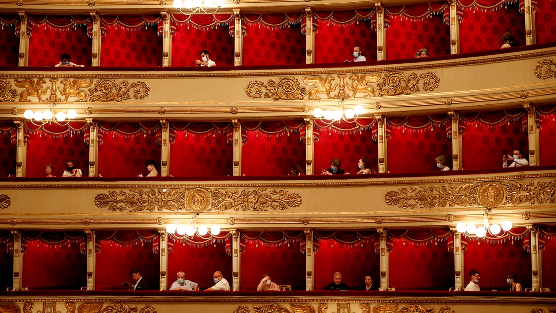 Spectators wearing masks attend a show at the La Scala theater in Milan Italy, July 6, 2020. 