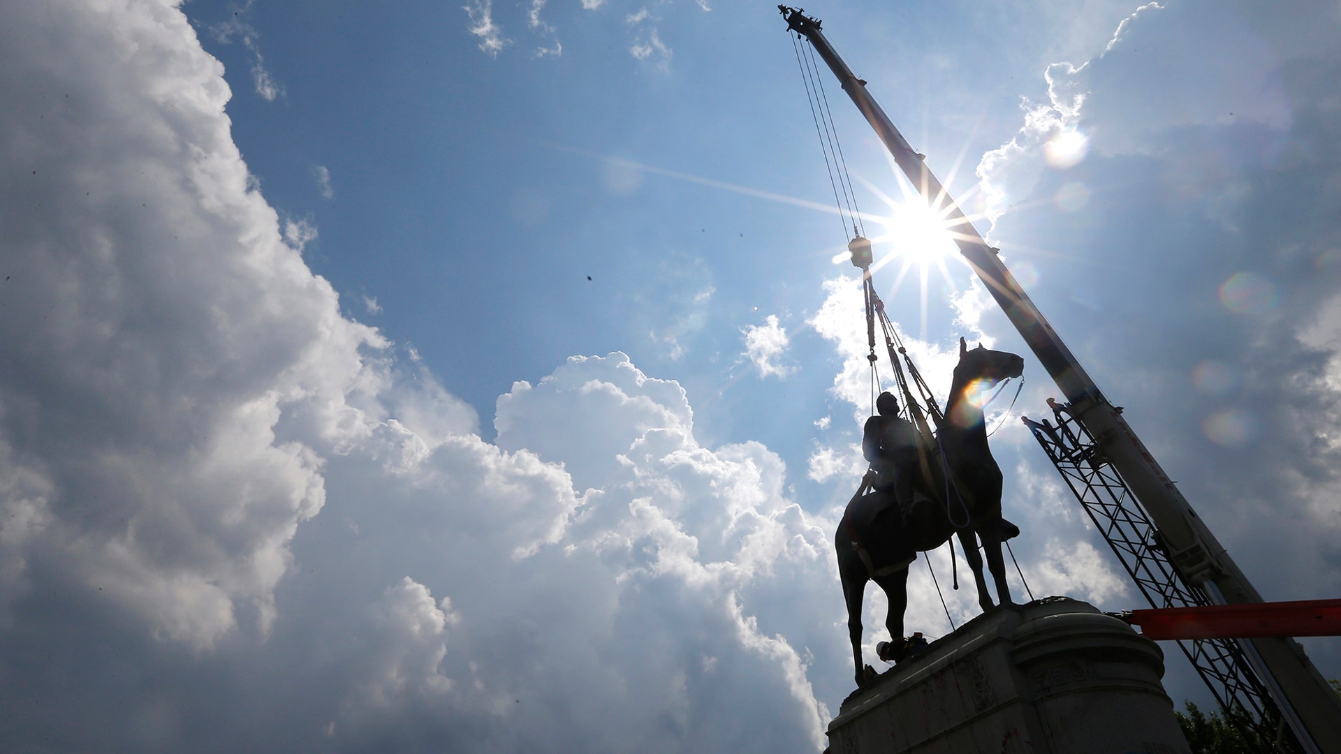 Work crews work to remove the statue of confederate general Stonewall Jackson in Richmond, Virginia, July 1, 2020. 
