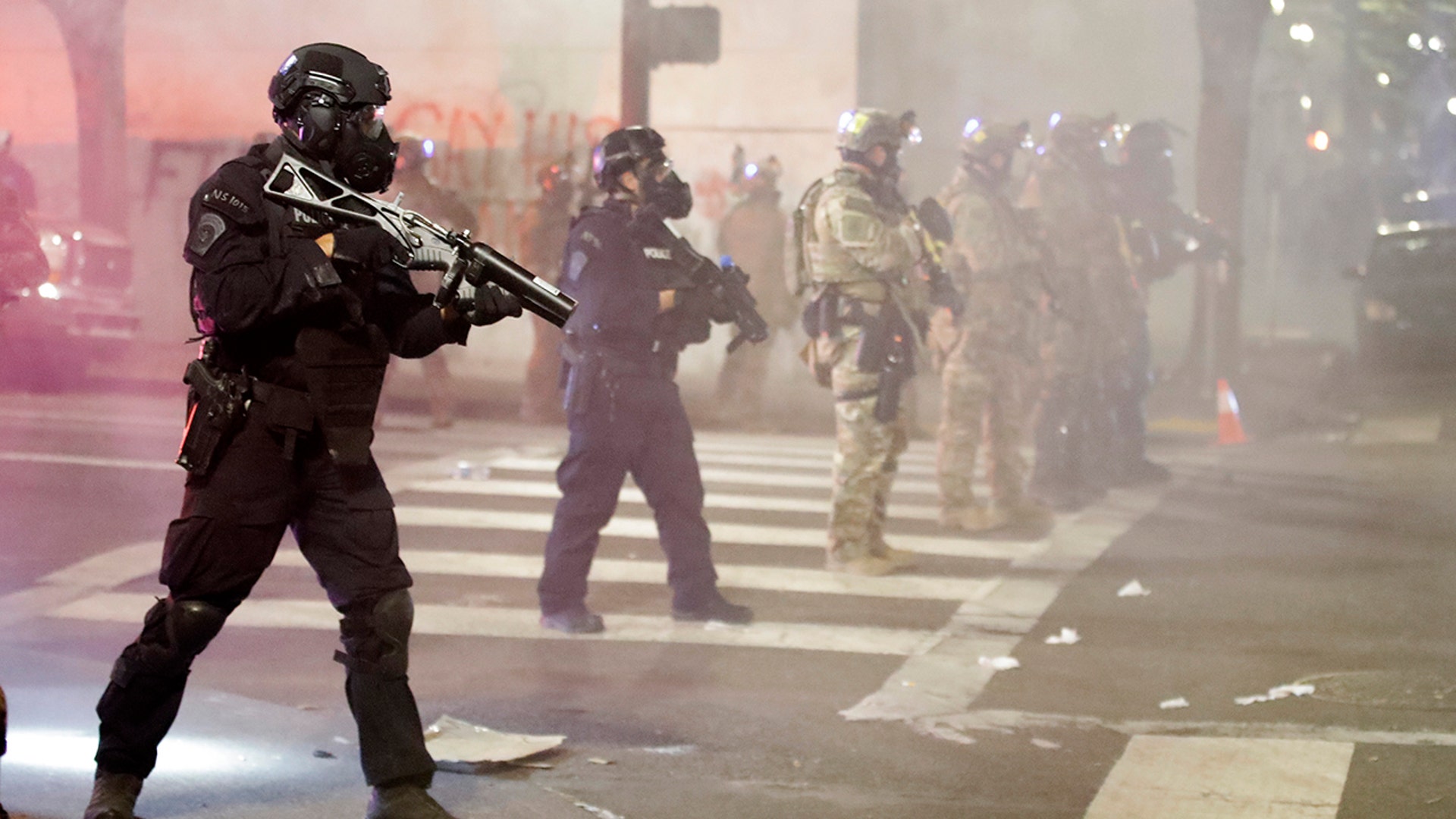 Federal officers deploy tear gas and crowd-control munitions at demonstrators during a Black Lives Matter protest at the Mark O. Hatfield U.S. Courthouse Tuesday, July 28, 2020, in Portland, Ore.