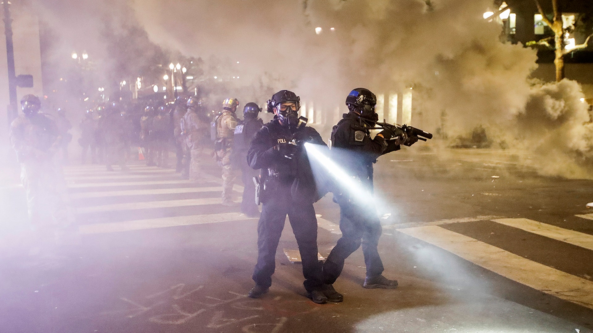 Federal officers deploy tear gas and crowd-control munitions at demonstrators during a Black Lives Matter protest at the Mark O. Hatfield U.S. Courthouse Tuesday, July 28, 2020, in Portland, Ore.