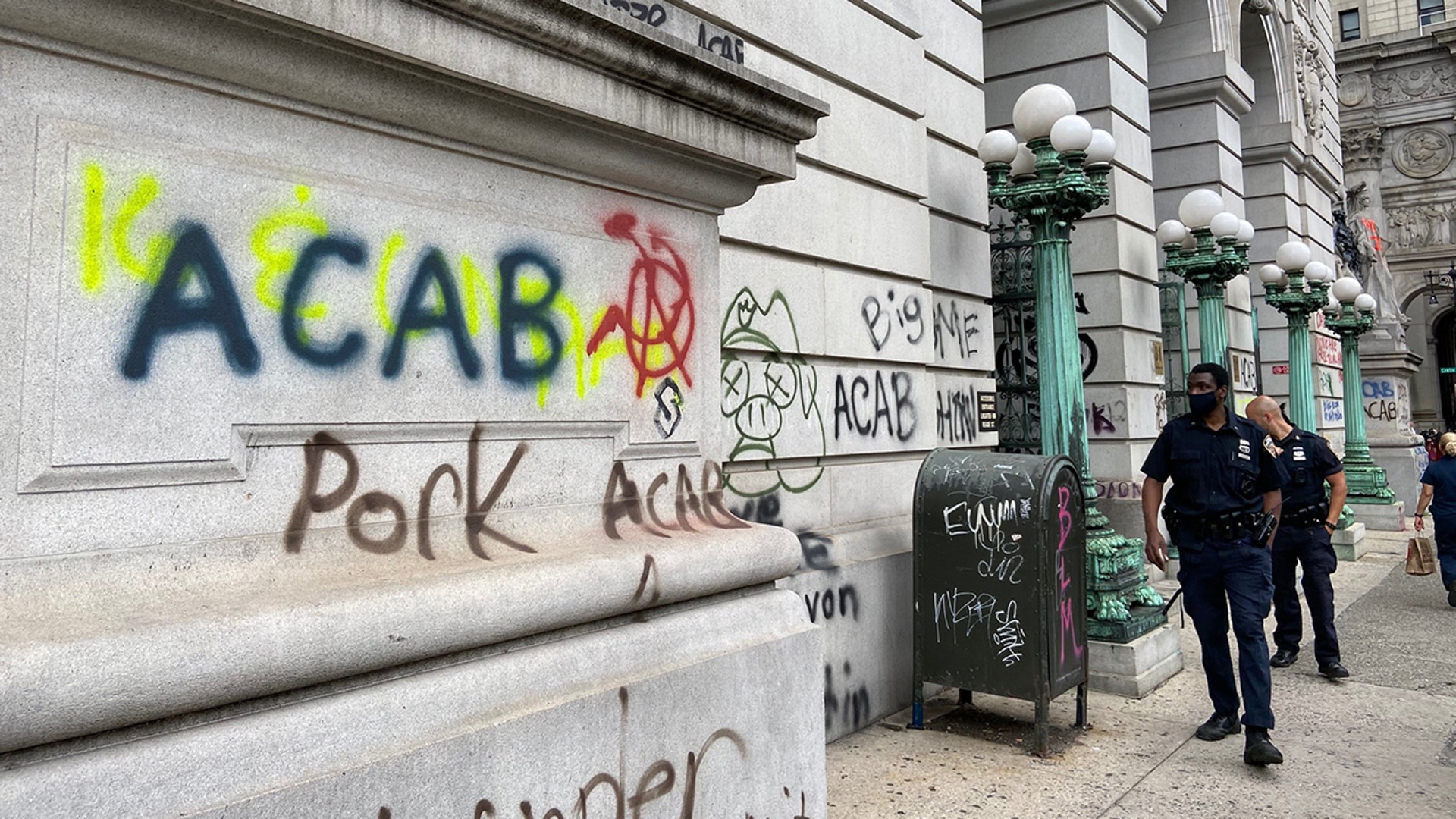 Hundreds of protesters continued their occupation of City Hall overnight, following Tuesday night's vote that included $837 million in budget cuts to the NYPD. In the photo, a graffiti-covered court building at 31 Chambers St.