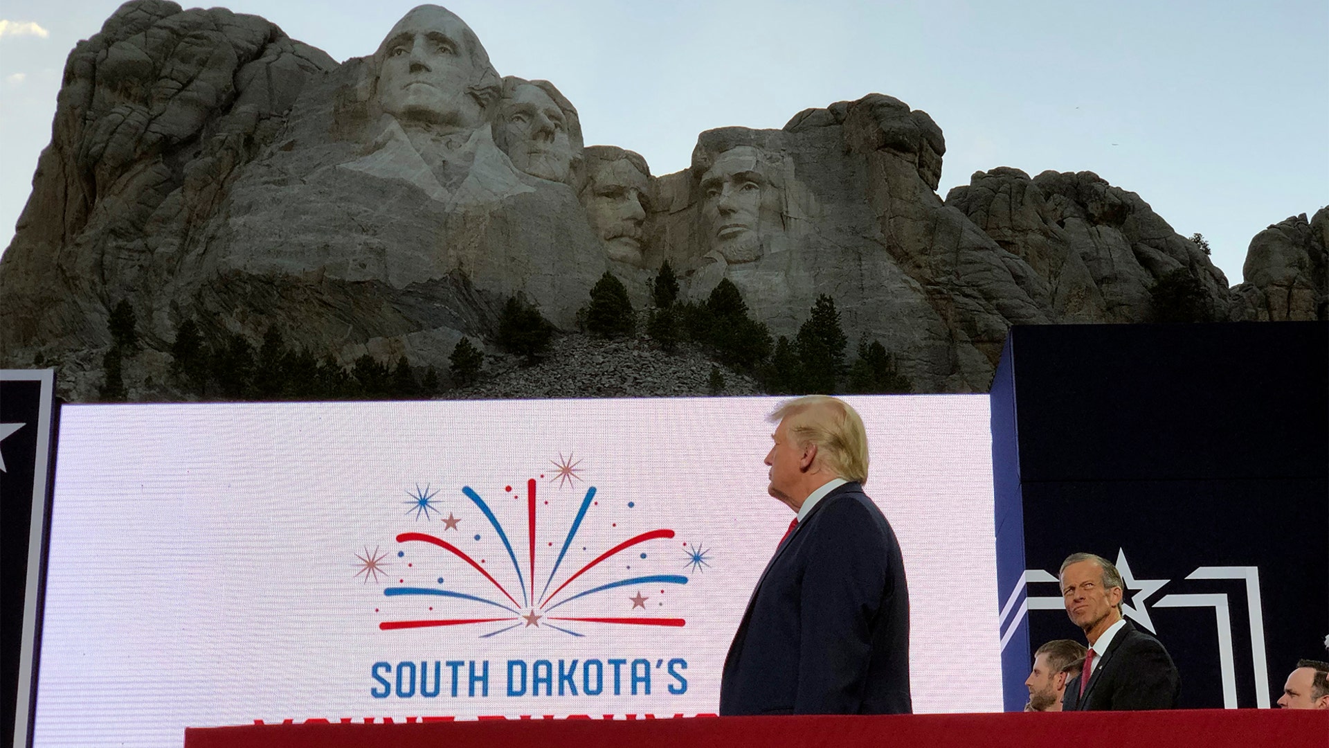 President Donald Trump stands on stage before he speaks at the Mount Rushmore National Monument on July 3, 2020, in Keystone, S.D.