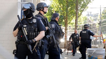 Seattle demonstrators damage, loot buildings as officer hospitalized