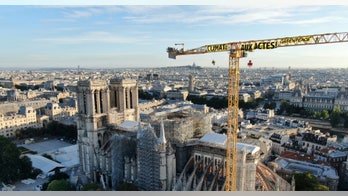 Greenpeace activists hang banner on Notre Dame Cathedral crane