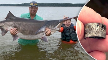 Oklahoma dad's paddlefish catch breaks record -- fish was tagged in 1997