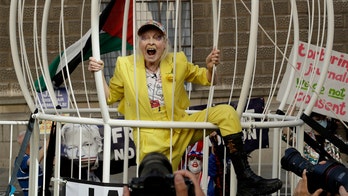 Designer Vivienne Westwood supports Julian Assange with odd protest in massive birdcage