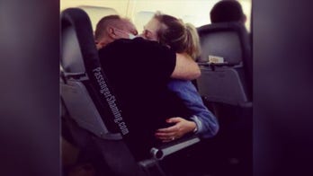 Airplane passengers appear to kiss while still wearing face masks, become social media stars