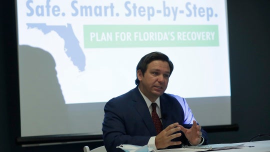 Florida governor encourages people to visit on commercial flights as coronavirus cases decrease