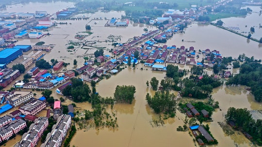 China flooding leaves thousands trapped after levees fail, another dam at risk of breaking