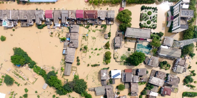 In this aerial photo released by Xinhua News Agency, a village is flooded in Sanjiao Township of the Yongxiu County in eastern China's Jiangxi Province  July 13.