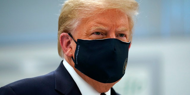 President Trump wears a face mask as he participates in a tour of Bioprocess Innovation Center at Fujifilm Diosynth Biotechnologies, July 27, 2020, in Morrisville, N.C. (AP Photo/Evan Vucci)