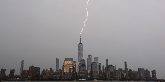 JERSEY CITY, NJ - JULY 22: A bolt of lightning hits One World Trade Center in lower Manhattan during a thunderstorm in New York City on July 22, 2020 as seen from Jersey City, NJ. (Photo by Gary Hershorn/Getty Images)