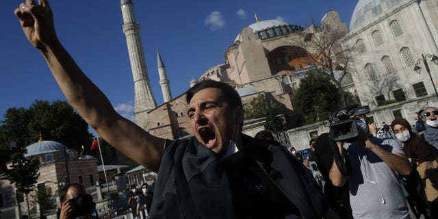 People chant slogans following Turkey's Council of State's decision, outside the Byzantine-era Hagia Sophia, one of Istanbul's main tourist attractions in the historic Sultanahmet district of Istanbul, Friday, July 10, 2020.