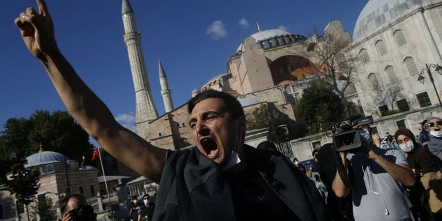 People chant slogans following Turkey's Council of State's decision, outside the Byzantine-era Hagia Sophia, one of Istanbul's main tourist attractions in the historic Sultanahmet district of Istanbul, Friday, July 10, 2020.