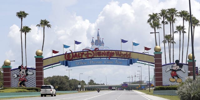 Cars drive under a sign greeting visitors near the entrance to Walt Disney World, Thursday, July 2, 2020, in Lake Buena Vista, Fla. Despite a huge surge of Floridians testing positive for the new coronavirus in recent weeks, Magic Kingdom and Animal Kingdom, two of Disney World's four parks are reopening Saturday, July 11. When they do, visitors to “The Most Magical Place on Earth” will find new rules in place.
