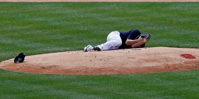 New York Yankees pitcher Masahiro Tanaka lies on the field after being hit by a ball off the bat of Yankees Giancarlo Stanton during a baseball a workout at Yankee Stadium in New York, Saturday, July 4, 2020. (Associated Press)