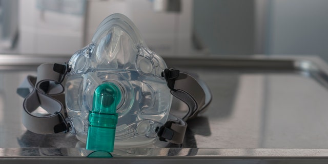 Non-invasive ventlation face mask, on background medical ventilator in ICU n hospital.