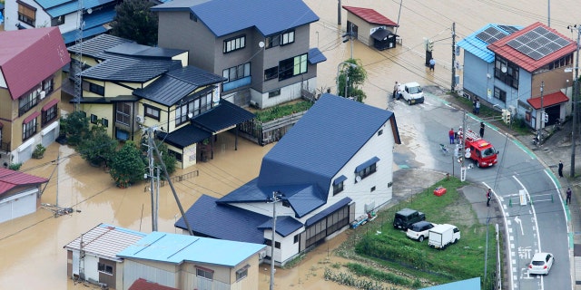 A residential area is flooded following a heavy rain in Okura village, Yamagata prefecture, northern Japan Wednesday, July 29, 2020.