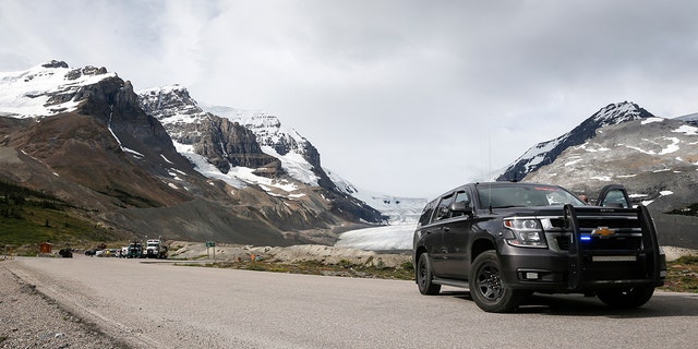 Royal Canadian Mounted Police attend the scene of a sightseeing bus rollover at the Columbia Icefields near Jasper, Alta., Sunday, July 19, 2020.