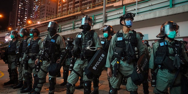 Riot police stand guard after pushing back protesters demonstrating against the new security law during the anniversary of the Hong Kong handover from Britain, Wednesday, July. 1, 2020, in Hong Kong. Hong Kong police have made their first arrests under a new national security law imposed by mainland China. The law, which took effect Tuesday night, makes activities deemed subversive or secessionist punishable by up to life in prison. (AP Photo/Vincent Yu)