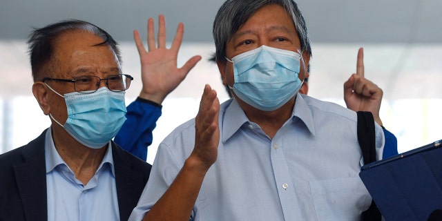 Pro-democracy activists Lee Cheuk-Yan, right, and Yeung Sum speak to media outside a district court in Hong Kong on Thursday. (AP Photo/Kin Cheung)