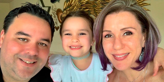 Michelle Zymet, and her husband John Place and their daughter Cyann. (Michelle Zymet via AP)