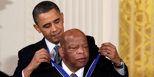 In this Feb. 15, 2011, file photo, President Barack Obama presents a 2010 Presidential Medal of Freedom to U.S. Rep. John Lewis, D-Ga., during a ceremony in the East Room of the White House in Washington. Lewis, who carried the struggle against racial discrimination from Southern battlegrounds of the 1960s to the halls of Congress, died Friday, July 17, 2020. (AP Photo/Carolyn Kaster, File)