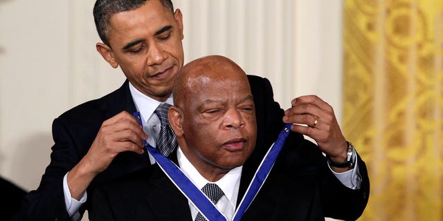 In this Feb. 15, 2011, file photo, President Barack Obama presents a 2010 Presidential Medal of Freedom to U.S. Rep. John Lewis, D-Ga., during a ceremony in the East Room of the White House in Washington. 