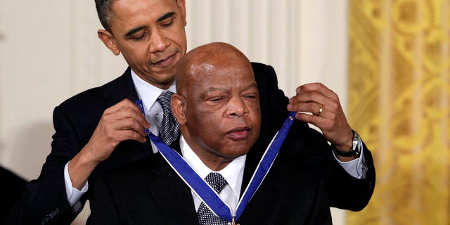 In this Feb. 15, 2011, file photo, President Barack Obama presents a 2010 Presidential Medal of Freedom to U.S. Rep. John Lewis, D-Ga., during a ceremony in the East Room of the White House in Washington. 