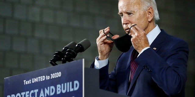 Democratic presidential candidate, former Vice President Joe Biden, puts on a face mask after speaking at an event in Lancaster, Pa. (AP Photo/Matt Slocum)