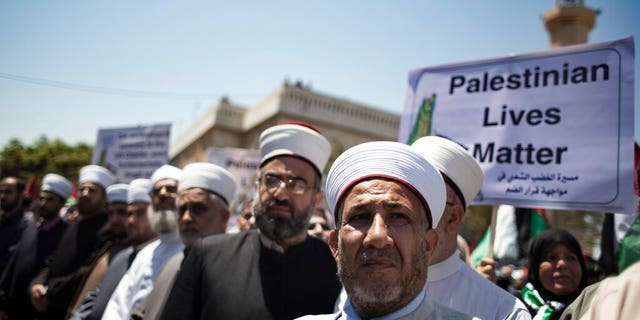 Palestinian Muslim clerics attend a demonstration against Israeli plans for the annexation of parts of the West Bank, in Gaza City, Wednesday, July 1, 2020. (AP Photo/Khalil Hamra)