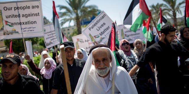 Palestinians demonstrate against Israeli plans for the annexation of parts of the West Bank, in Gaza City, Wednesday, July 1, 2020. (AP Photo/Khalil Hamra)