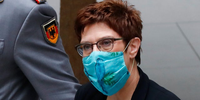 Defense Minister Annegret Kramp-Karrenbauer (CDU) arrives at a press conference on the reform of the Special Forces Command (KSK), wearing mouth and nose protection, Berlin Germany, Wednesday, July 1, 2020. Since 2017, the KSK has been making headlines because of several cases of right-wing extremism. One suspected soldier even had an arsenal dug up. The Defence Minister has therefore had a reform concept developed to counteract extremist tendencies. (Kay Nietfeld/dpa via AP)