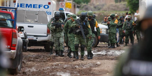 Members of the Mexico national guard walk near an unregistered drug rehabilitation center after a shooting in Irapuato, Mexico, on July 1. The violence occured in a region where the Jalisco New Generation Cartel reportedly is fighting for control of a $3 billion market in stolen gasoline. (AP)