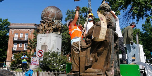 Workers remove the statue of Confederate Naval officer Matthew Fontaine Maury on Monument Avenue Thursday July 2, 2020, in Richmond, Va.