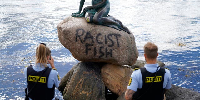 Police stand by the statue of the Little Mermaid, after it was vandalized, in Copenhagen, Denmark, Friday, July 3, 2020. 